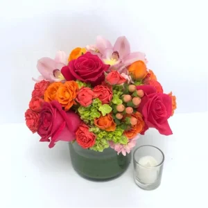 Mother's Day bouquet with bright roses, orchids, and hydrangeas in a glass vase