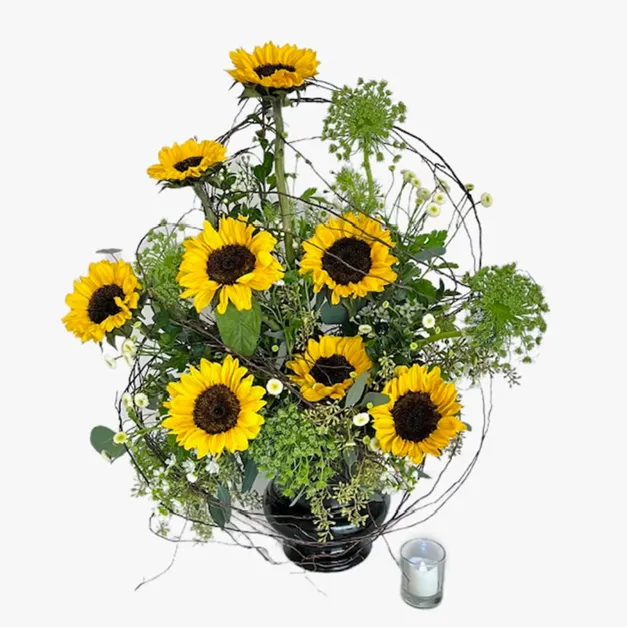 Yellow floral arrangement with sunflowers in a black vase