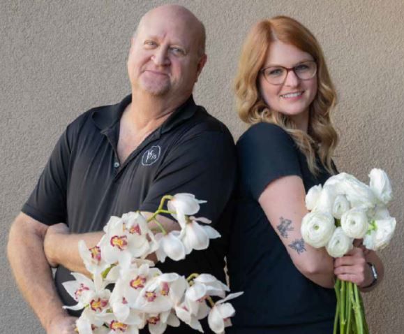 PJs Flowers team members demonstrating flower care and handling with orchids and ranunculus