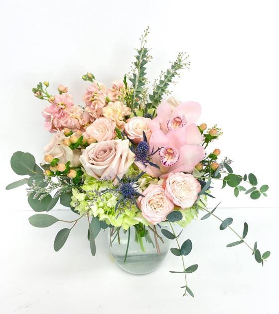 Pink and blush bouquet with roses and orchids showing how flowers boost mood and improve emotional well-being