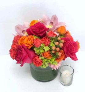Vibrant orange and red rose bouquet with orchids showing how flowers boost mood and improve emotional well-being