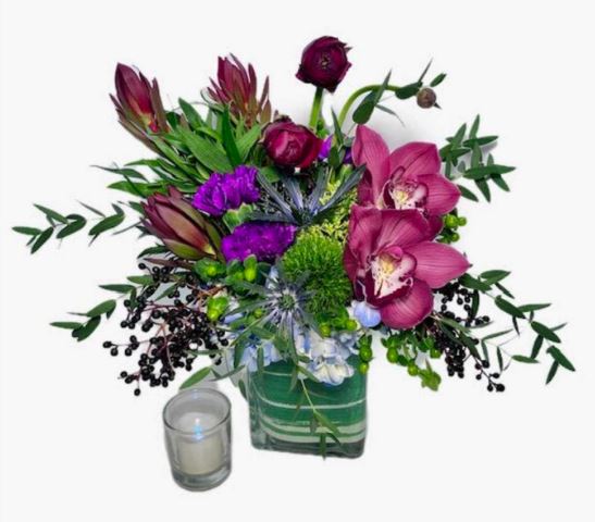 Birthday flowers in Phoenix featuring magenta orchids, deep red ranunculus, and purple accents by PJ's Flowers